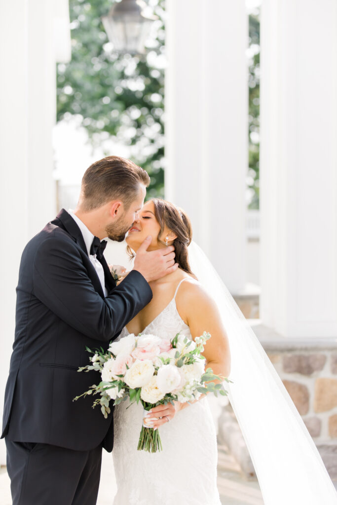 A bride and groom sharing a kiss.