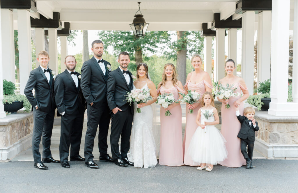 A bridal party portrait with bridesmaids, groomsmen and a flower girl and ring bearer.