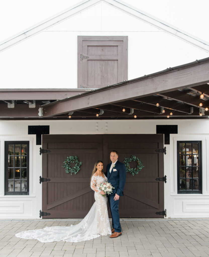 Bride and groom at the Hamilton Manor in front of the barn doors.